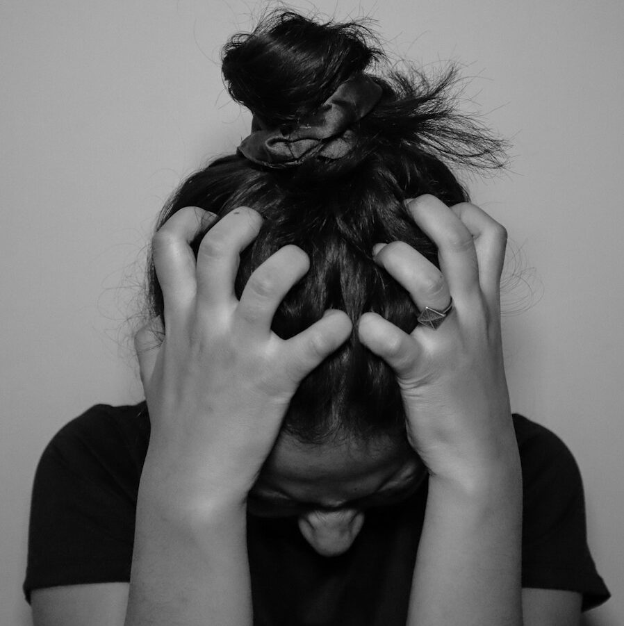 a woman covering her face with her hands