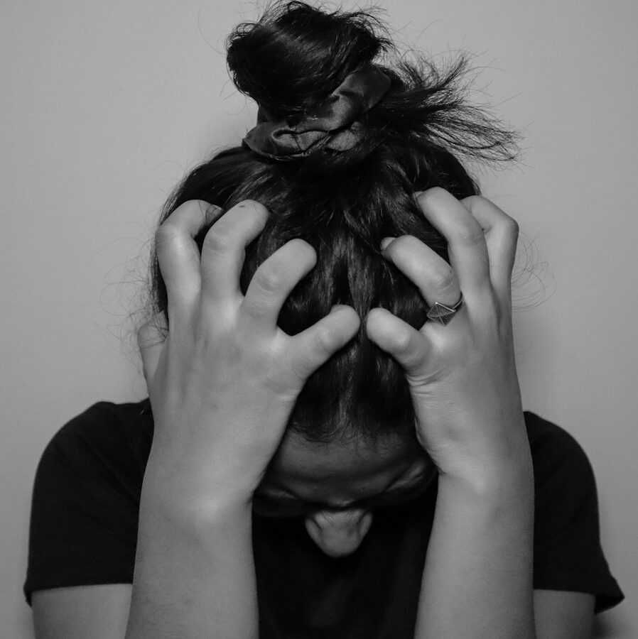 a woman covering her face with her hands